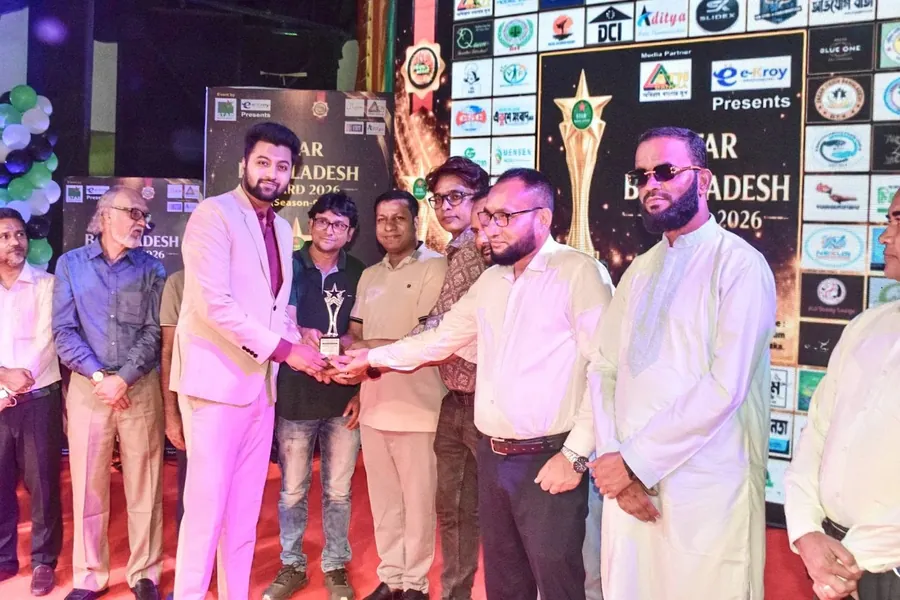 Mir Ahadul Islam receiving the Star Bangladesh Award trophy on stage at the Star Bangladesh Award 2026 ceremony